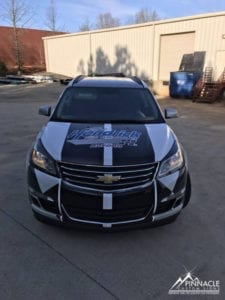 Front view of a Chevrolet vehicle with custom graphics for Rick Hendrick Chevrolet Buford, displaying the dealership logo, created by Pinnacle Custom Signs.