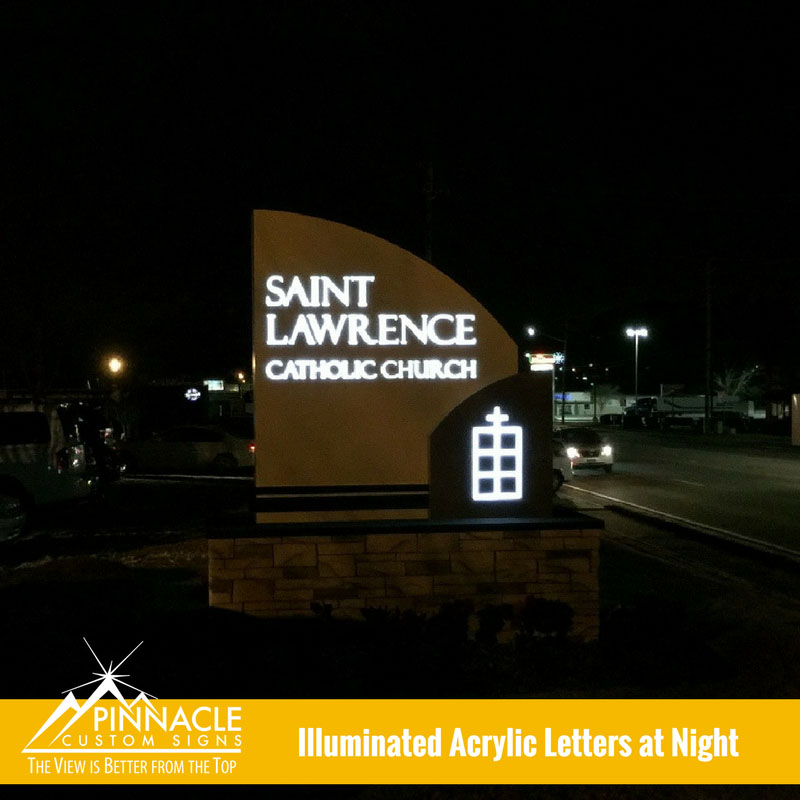 The view at night of the new lighted monument sign for Saint Lawrence Catholic Church